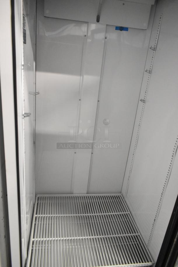 2021 True TSCI-600R-G-PH commercial cooler with single glass door and poly-coated racks, 115 volts, 1 phase.