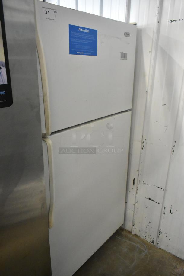 Whirlpool ET1MHKXMQ06 metal reach-in cooler with freezer, 115 volts, 1 phase, white, visible wear, attention label on door.