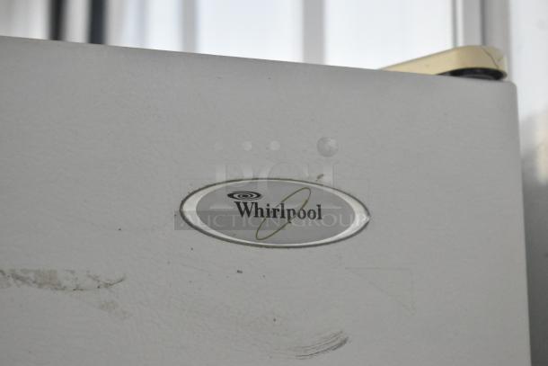 Whirlpool ET1MHKXMQ06 metal reach-in cooler with freezer, 115V, 1 phase, slight exterior wear, Whirlpool logo visible.
