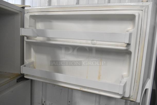 Whirlpool ET1MHKXMQ06 metal reach-in cooler with freezer, 115 volts, 1 phase, open door view showing interior shelving.