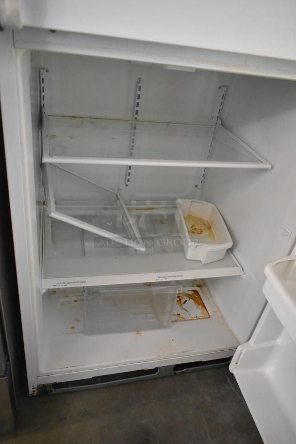 Whirlpool ET1MHKXMQ06 metal reach-in cooler with freezer, visible interior shelves, some stains, 115V, 1 phase.