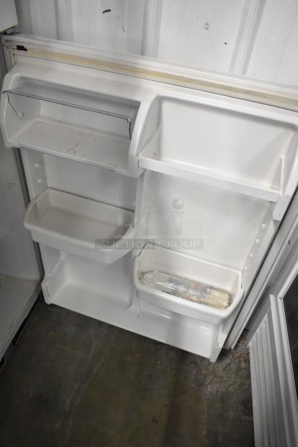 Whirlpool ET1MHKXMQ06 metal reach-in cooler with freezer, showing interior shelves and door storage. 115V, 1 Phase.