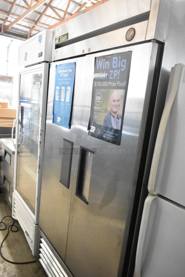 True T-35 stainless steel commercial 2-door cooler, 115 volts, visible tags and posters, good condition.