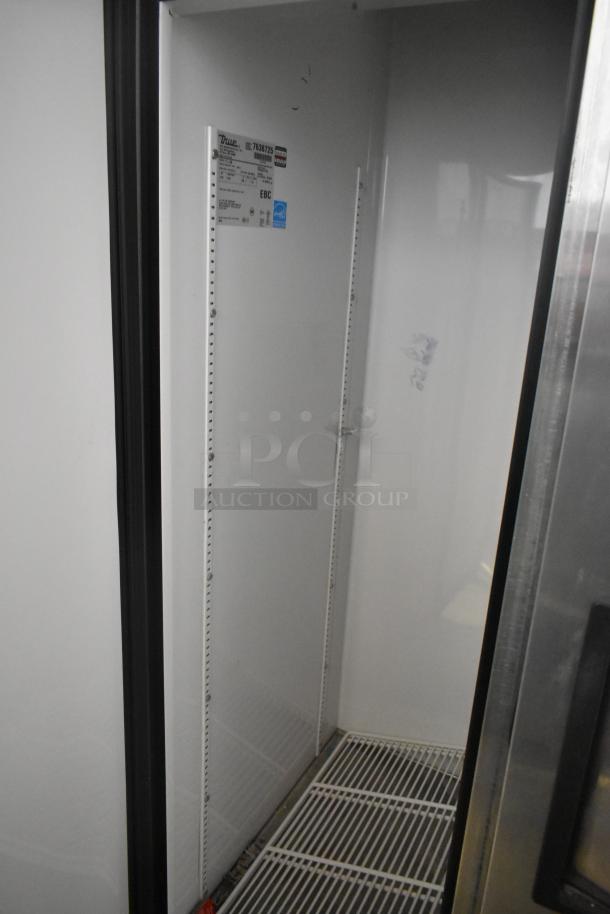 True T-35 commercial 2-door stainless steel cooler, 115 volts, 1 phase. Features shelving, internal label visible.