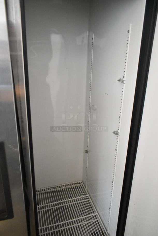 True T-35 stainless steel commercial 2 door reach-in cooler interior, clean condition, shelving brackets visible.