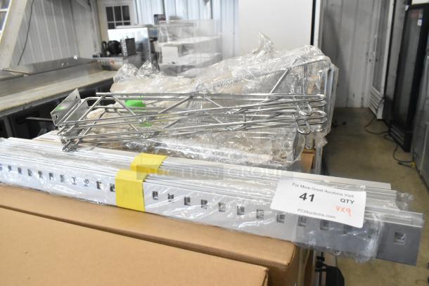 Lot of 9 brand new chrome finish shelf brackets, various items. Includes original packaging. Marked "41 QTY VX9".