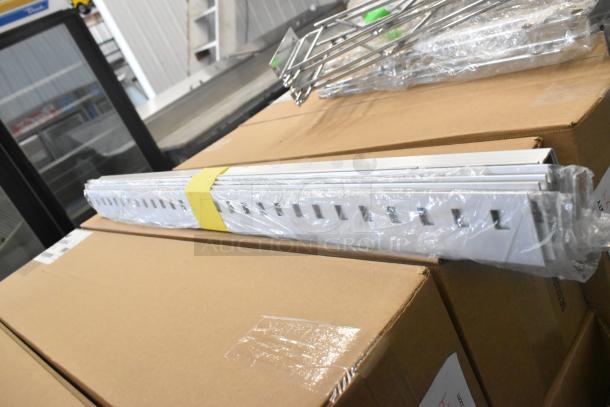 Lot of 9 items, including chrome finish shelf brackets, new with minor scratches. Items packed in boxes, ready for auction.