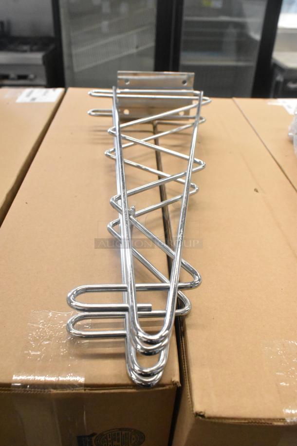 Lot of 9 chrome finish shelf brackets, brand new, scratch and dent condition, on cardboard surface.