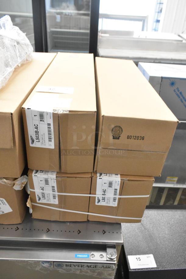 Four new Vollrath LS03IB-AC LidSaver™ 3 in-counter lid dispensers in boxes for 3 1/4"-3 3/4" lids.