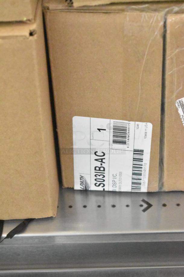 4 brand new Vollrath LS03IB-AC LidSaver™ 3 in-counter lid dispensers for 3 1/4" - 3 3/4" lids, with packaging showing model label.