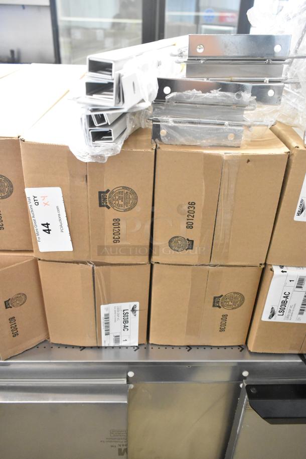 4 brand new Vollrath LS03IB-AC LidSaver™ 3 in-counter lid dispensers in boxes, labeled for 3 1/4" - 3 3/4" lids.