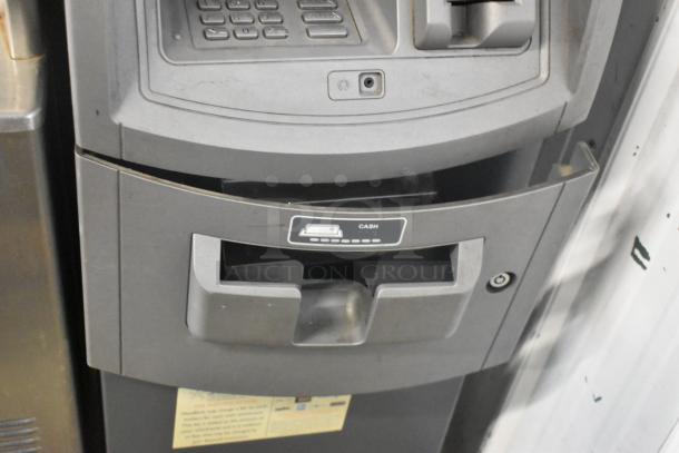 Hyosung metal floor style ATM with keypad and cash slot. Functional condition. Brand label visible.