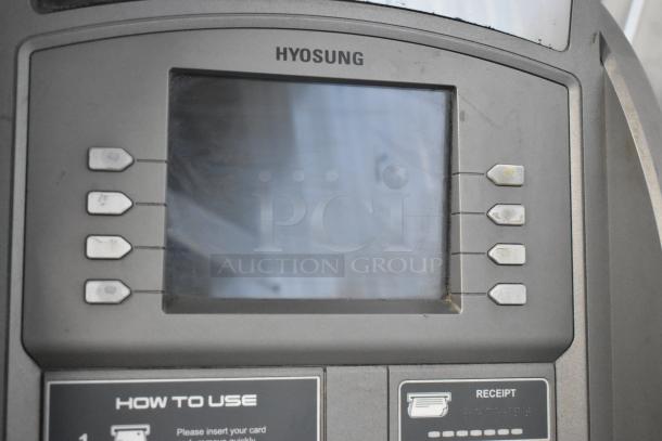 Hyosung metal floor style ATM with keypad and screen in used condition, visible instructions for card use and receipt.