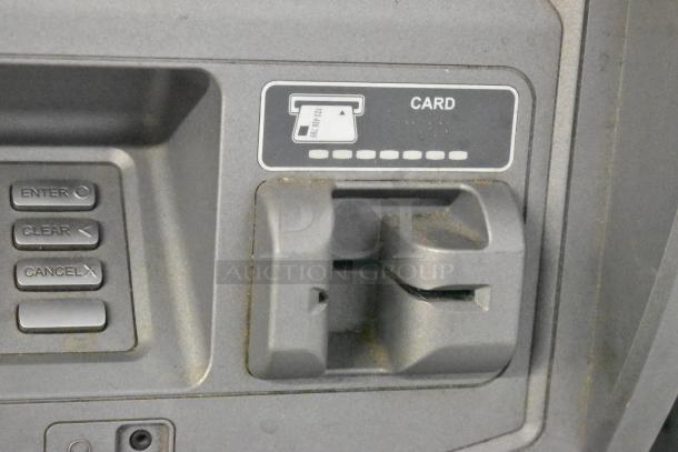 Hyosung metal floor-style ATM with card slot and keypad. Features "Enter," "Clear," "Cancel" buttons. Shows slight wear.