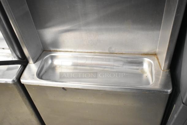 Taylor 441-33 stainless steel single-flavor soft serve ice cream machine; water cooled, on commercial casters; 208-230V, 3 phase.
