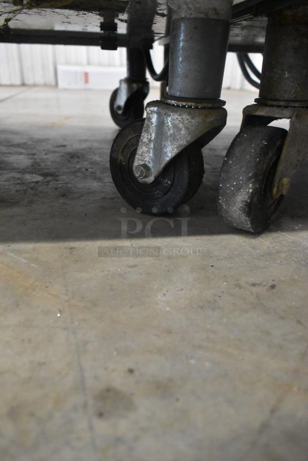 Taylor 441-33 soft serve machine on commercial casters showing wheel condition and floor surface.