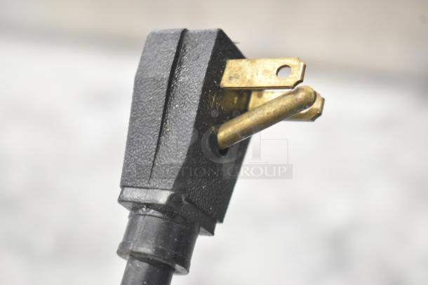 Close-up view of the plug from a Micro Matic MMPP4301 Glycol Chiller, showing a three-pronged power connection.