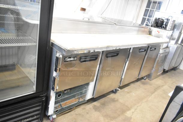 2021 Leader ESPT96 stainless steel pizza prep table with marble pattern cutting board, commercial casters, 115V, 1 phase.