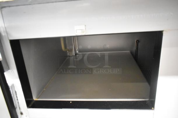 Interior view of 2021 Leader ESPT96 stainless steel commercial pizza prep table, showing a clean steel surface.