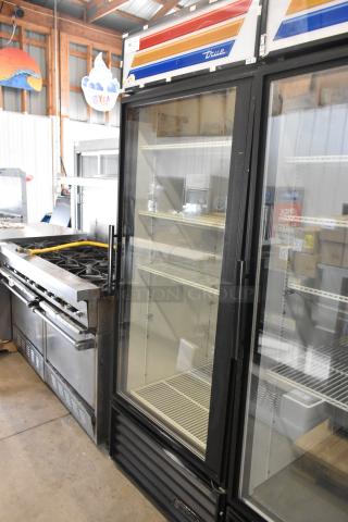 True GDM-26 single door cooler merchandiser with poly-coated racks, 115 volts, metal finish, clear front, spacious interior.