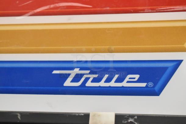 True GDM-26 single door commercial cooler, metal frame, with poly coated racks. Features True logo on exterior.