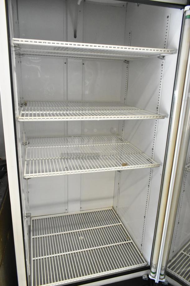 True GDM-26 commercial single door cooler merchandiser with poly coated racks, 115V, 1 phase, clean interior, good condition.