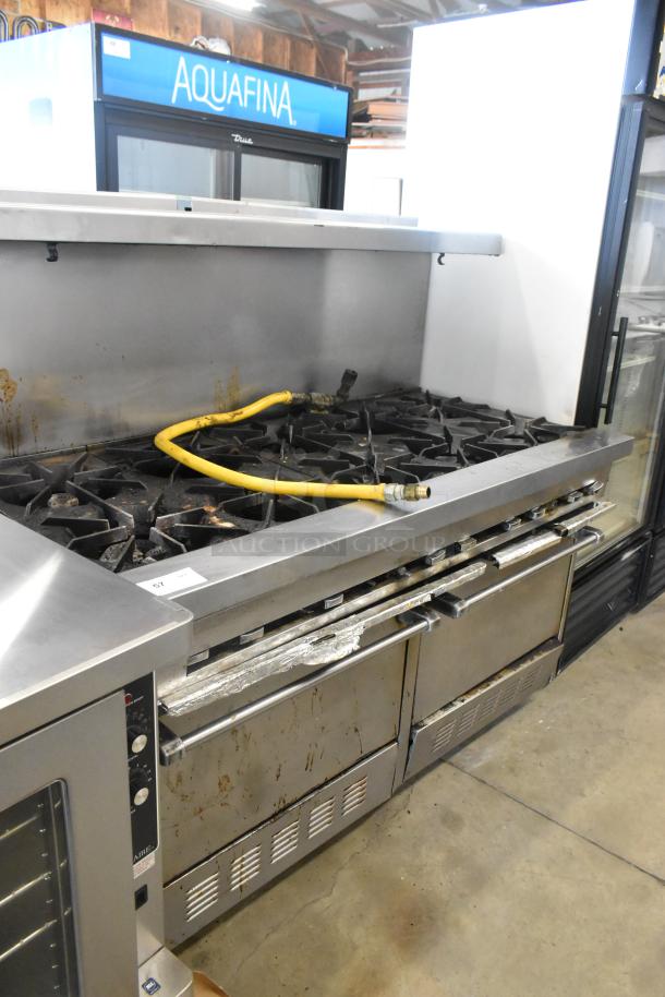 Garland SunFire stainless steel 10 burner gas range with 2 ovens, over shelf, and backsplash. Used condition with visible wear.