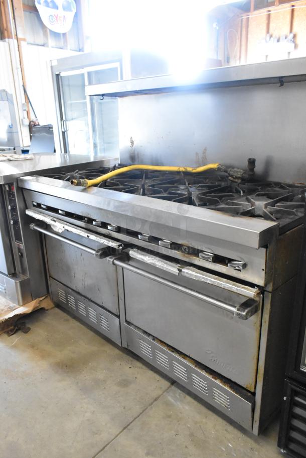 Garland SunFire commercial stainless steel 10-burner gas range with 2 ovens, over-shelf, and backsplash; visible wear.