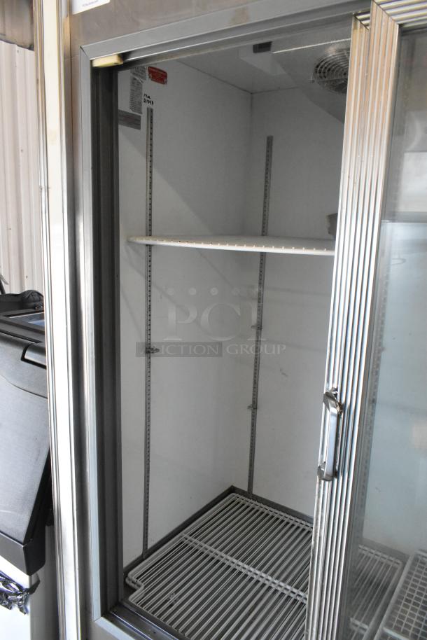 R-54SC Metal Commercial 2 Door Reach In Cooler, 115V, 1 Phase, features adjustable shelving, good condition.