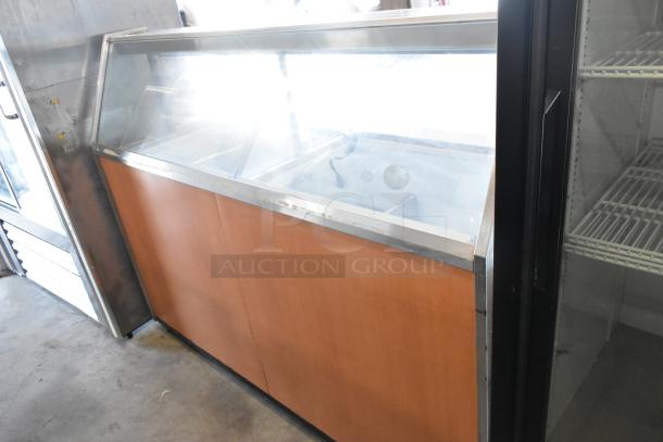 Metal commercial ice cream dipping cabinet with glass top and bucket collars. Good condition, wood front panel, metal frame.