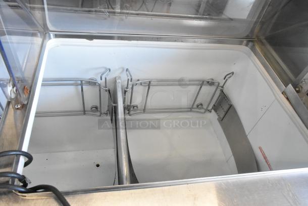 Metal commercial ice cream dipping cabinet with bucket collars, stainless steel finish, and sturdy interior, good condition.