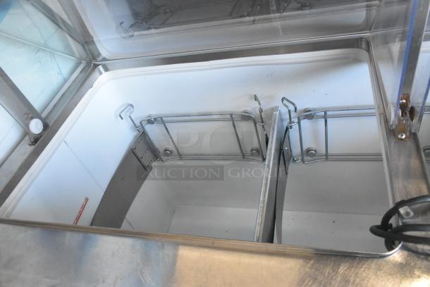 Metal commercial ice cream dipping cabinet with bucket collars, featuring a stainless steel interior and clear lids. Good condition.