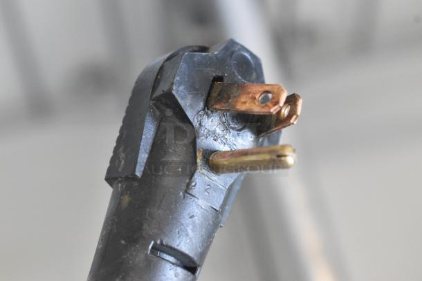Close-up view of a damaged electrical plug with bent prongs, showing visible signs of wear and tear.
