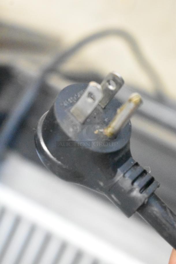 Close-up of 115V plug for 2018 True GDM-45-HC-LD cooler, showing three-prong design, compatible with standard outlets.
