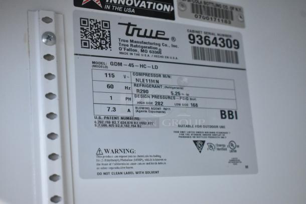 Label on True GDM-45-HC-LD commercial cooler, showing specifications: 115V, R290 refrigerant, 1 phase, model info.