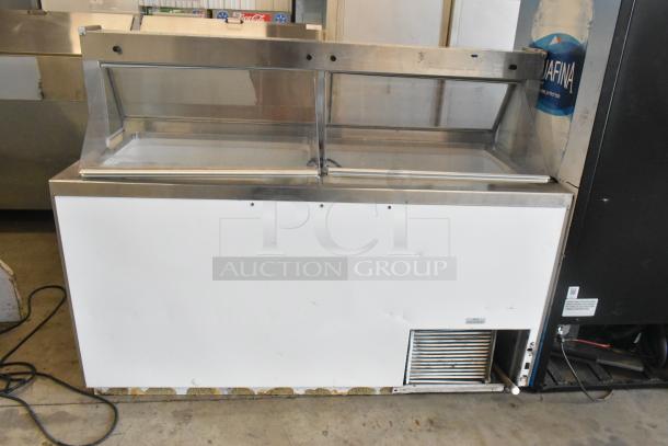 Metal commercial ice cream dipping cabinet with bucket collars, featuring a glass display, stainless steel frame, in used condition.