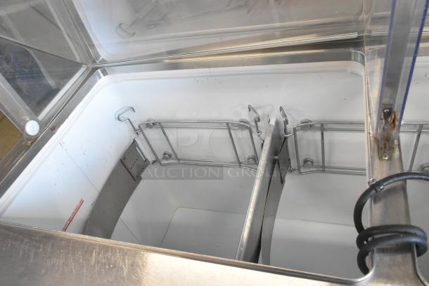 Metal commercial ice cream dipping cabinet with bucket collars. Features durable construction and internal metal holders.