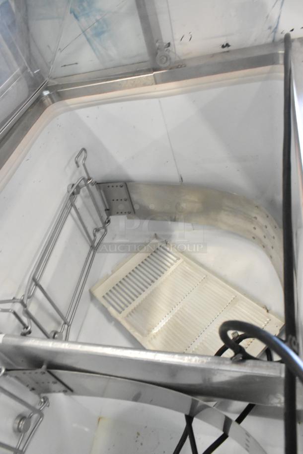 Metal commercial ice cream dipping cabinet with bucket collars, features stainless steel interior, good condition.