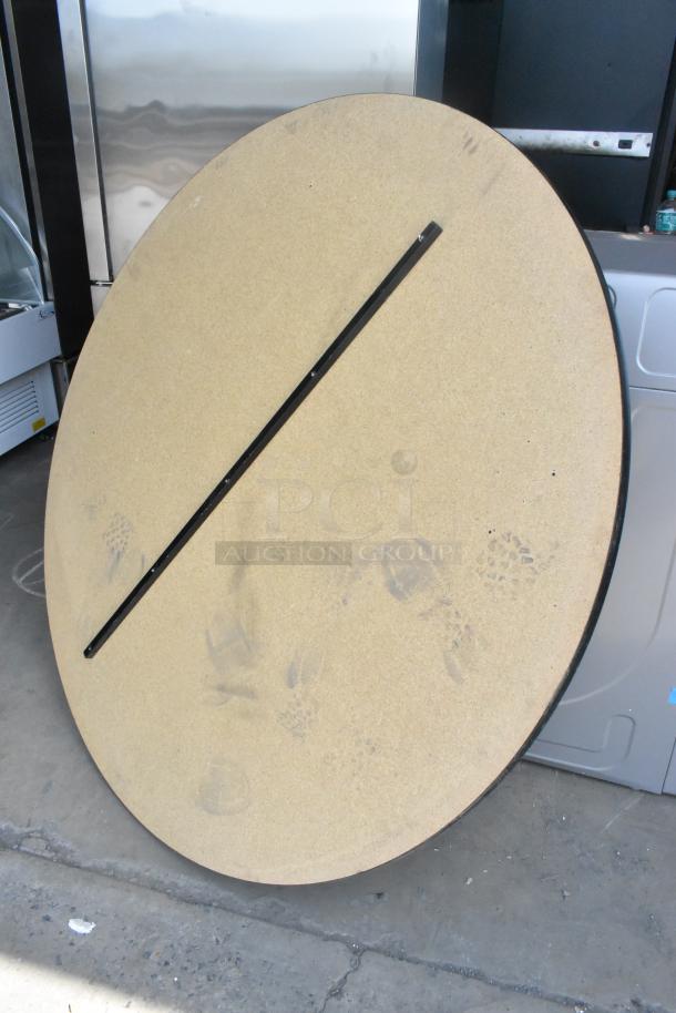Five round gray tabletops, featuring a smooth surface with visible edge banding, lightly used condition.