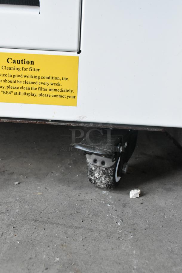 Brand new Avantco 193HAC28W air curtain merchandiser, 28" white, one shelf, LED lights, filter caution label visible.