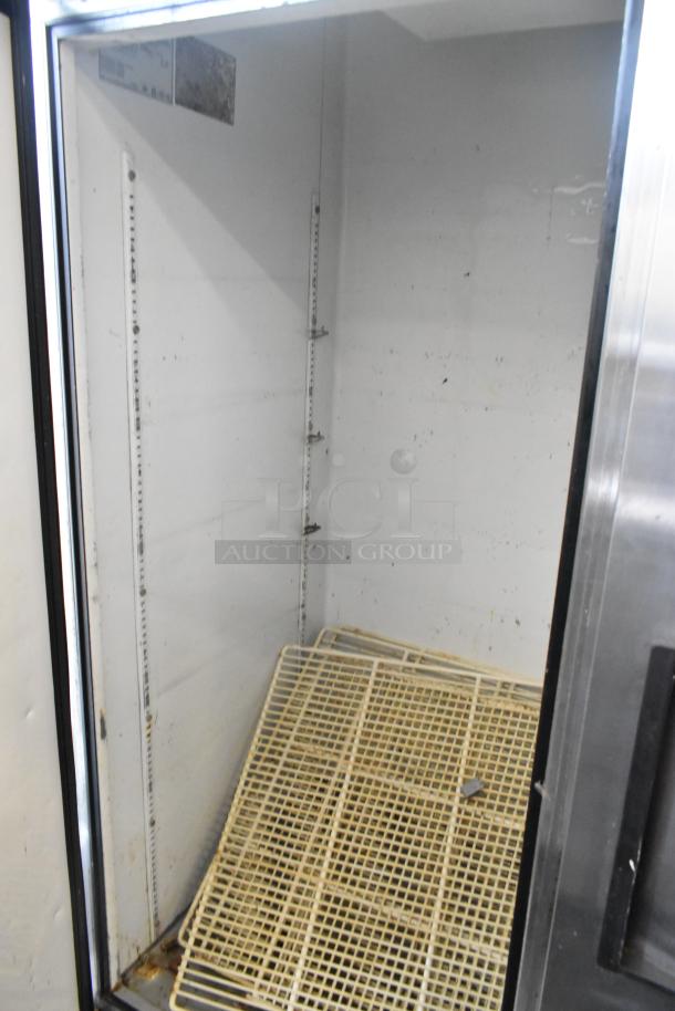 True T-49 Stainless Steel 2 Door Commercial Cooler, 115V, 1 Phase, interior shelves, model label visible, needs cleaning.