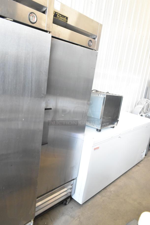 True T-19F stainless steel commercial single-door reach-in freezer on casters. Equipped with thermometer and handle.
