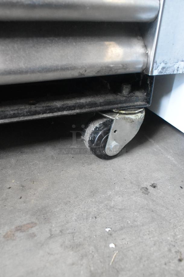True T-19F stainless steel reach-in freezer on commercial casters, showing a close-up of its sturdy, movable wheel.