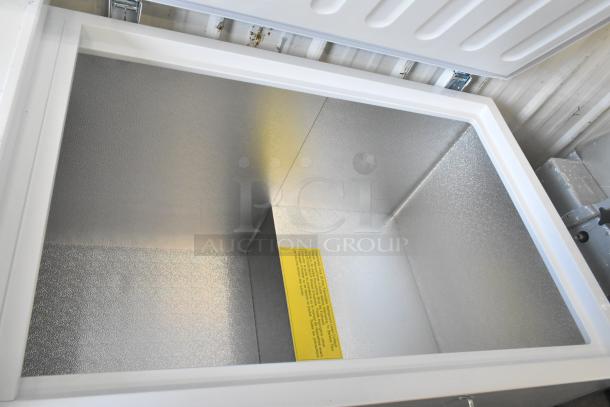 Brand new Galaxy 177CF25HC metal chest freezer with 2 hinge lids, 115 volts, scratch and dent, interior label visible.