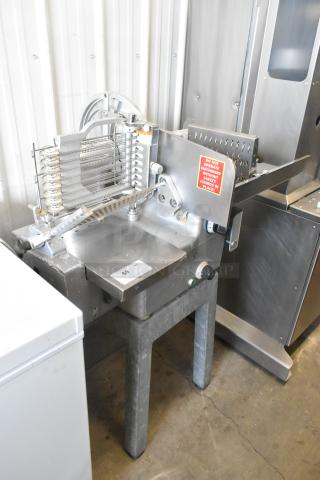 Bizerba 330 metal commercial floor-style meat slicer stacker, 115 volts, 1 phase, in used condition. Visible safety labels.