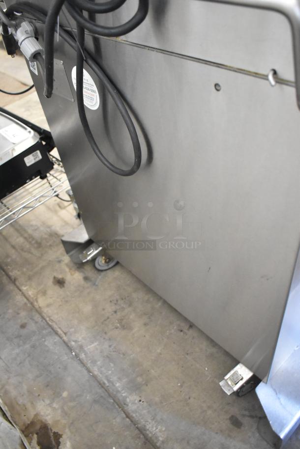 Fresh N Squeeze POS-1 citrus juicer, stainless steel, commercial floor style, on casters, 115V, 1 phase, visible wiring.