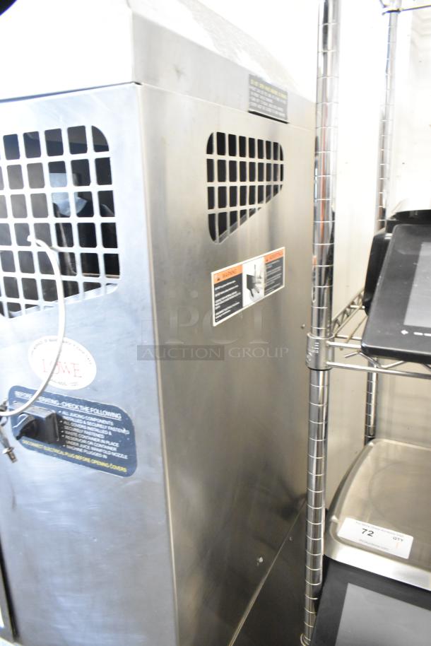 Stainless steel Fresh N Squeeze POS-1 citrus juicer, commercial floor model, on casters, 115 volts, 1 phase. Visible labels show safety and usage instructions.