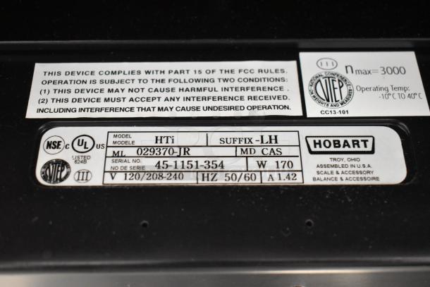 2016 Hobart HTi Metal Commercial Food Portioning Scale label showing model, voltage, serial number, and compliance info.
