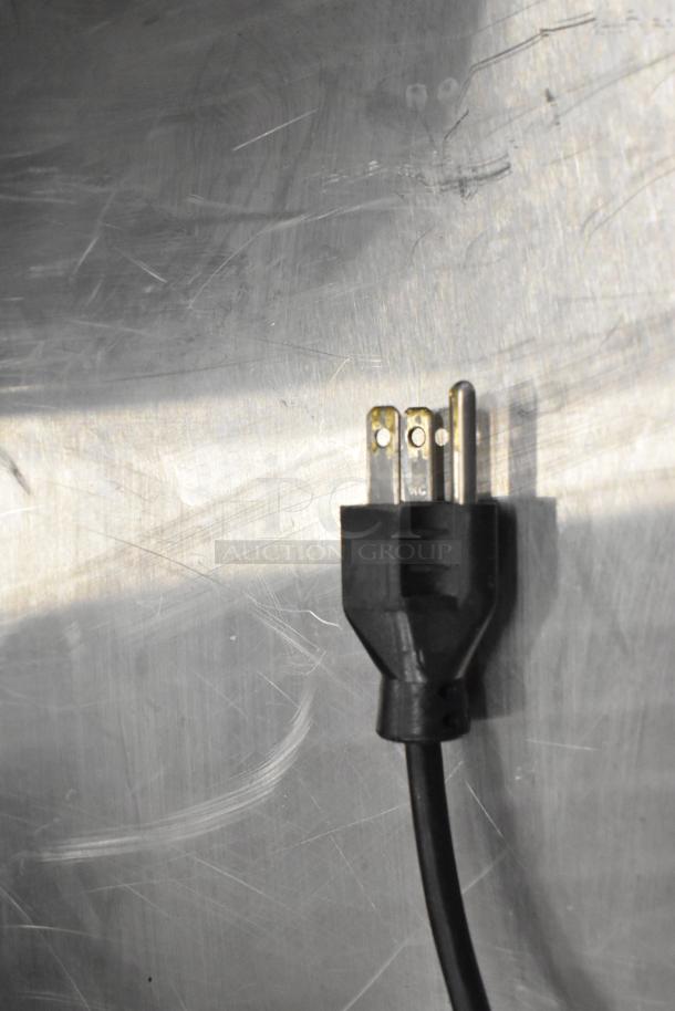 Close-up of a power plug on a Hobart HTi commercial countertop food portioning scale. 120/208-240 Volts, 1 Phase.