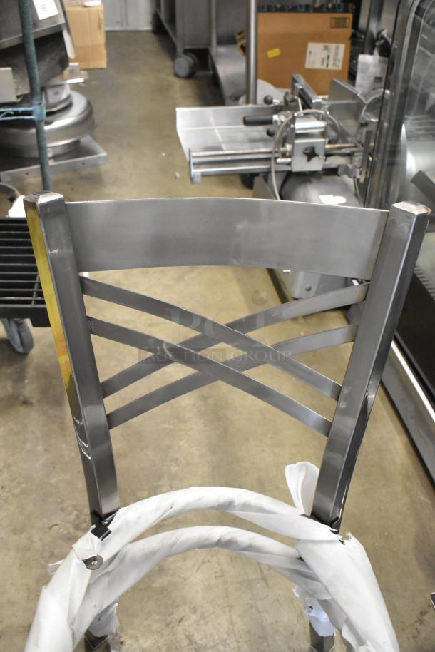 Gray metal dining height chair frame, cross back design, brand new with scratch and dent condition, wrapped in protective material.